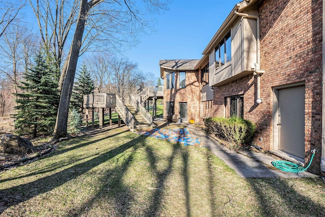 view of yard featuring a wooden deck and stairs