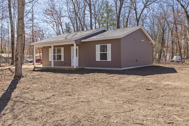 8995 Chippewa Trl, Howard City, MI 49329 - view of front facade featuring roof with shingles and a porch