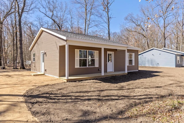 8995 Chippewa Trl, Howard City, MI 49329 - bungalow-style house featuring covered porch
