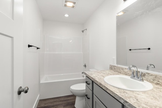 8995 Chippewa Trl, Howard City, MI 49329 - full bath featuring wood finished floors, visible vents, toilet, vanity, and shower / bathing tub combination