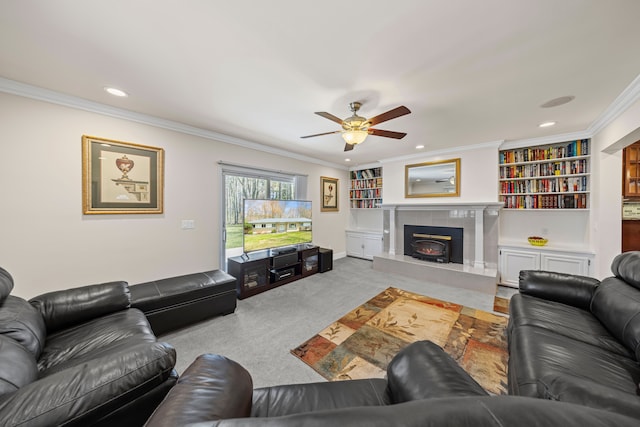 living area with crown molding, a tiled fireplace, carpet, a ceiling fan, and recessed lighting