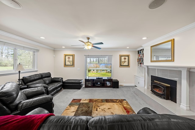 carpeted living room featuring crown molding, a wood stove, baseboards, ceiling fan, and recessed lighting
