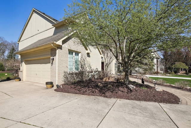 1391 Woodbridge Ct, Wixom, MI 48393 - view of side of property with brick siding, a garage, and driveway