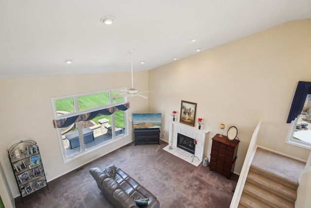 carpeted living area featuring plenty of natural light, ceiling fan, and lofted ceiling