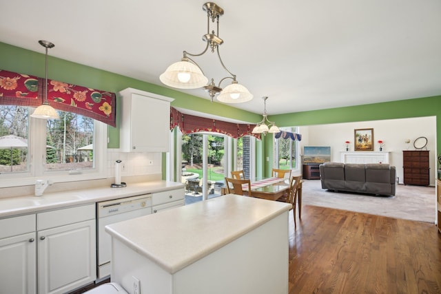 kitchen with white cabinetry, plenty of natural light, a sink, and dishwasher