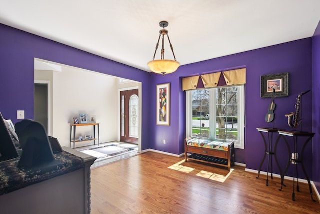 interior space featuring baseboards and wood finished floors