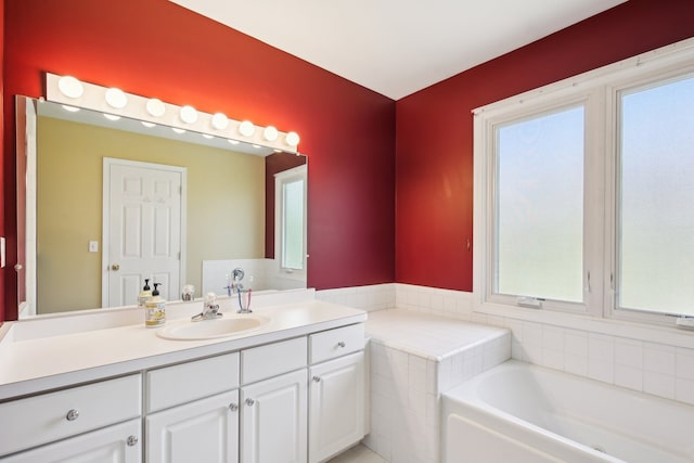 full bathroom with a healthy amount of sunlight, vanity, and a garden tub