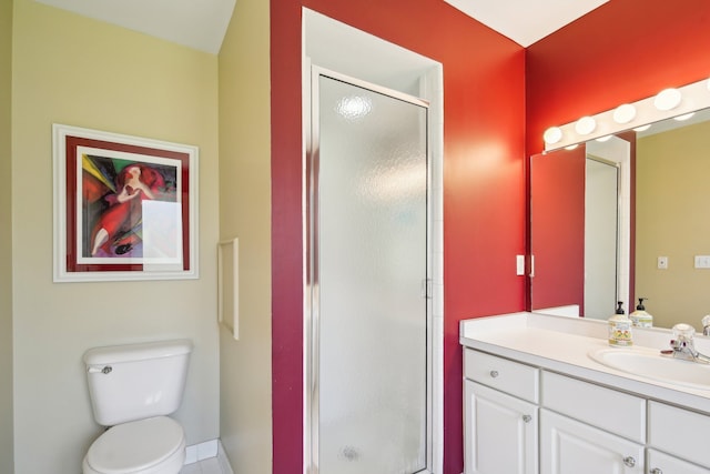 full bath featuring vanity, baseboards, toilet, and a shower stall