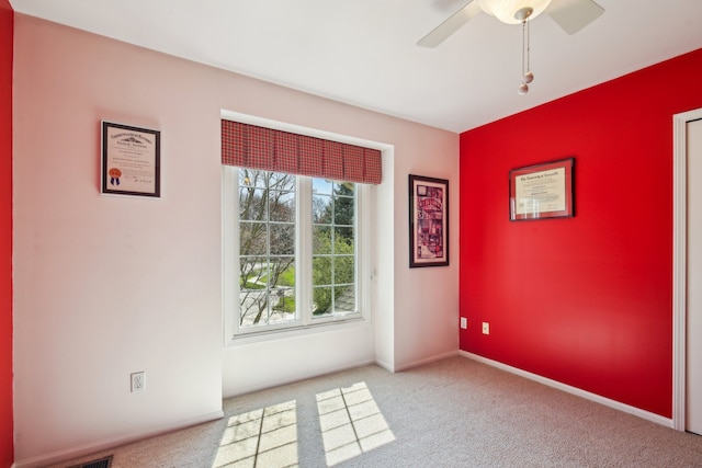 empty room with carpet and ceiling fan