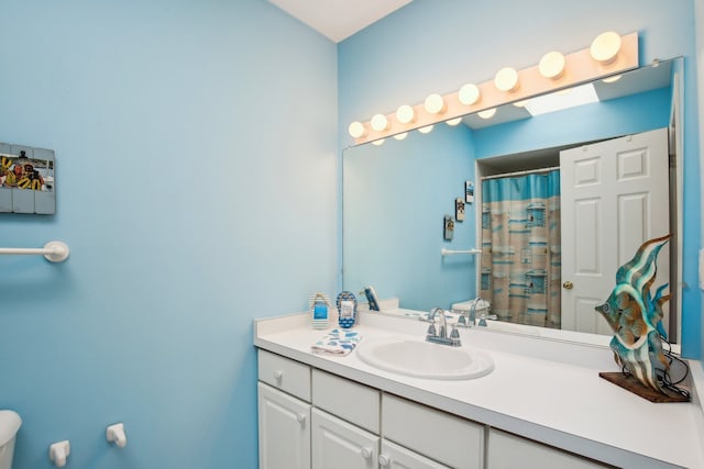 bathroom with vanity, toilet, and a shower with curtain