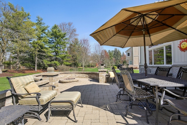 view of patio featuring outdoor dining area and an outdoor fire pit