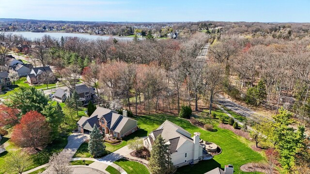 drone / aerial view featuring a water view and a residential view