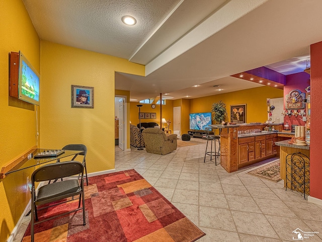 interior space with baseboards, a textured ceiling, and recessed lighting