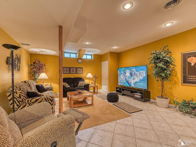 living room with recessed lighting, visible vents, and baseboards