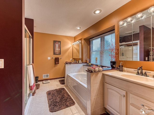 full bath with tile patterned floors, a textured ceiling, a stall shower, a bath, and visible vents