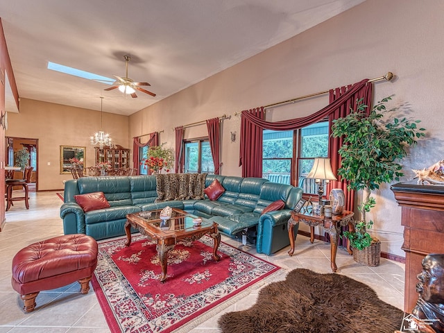 living room with tile patterned floors, a towering ceiling, and ceiling fan with notable chandelier