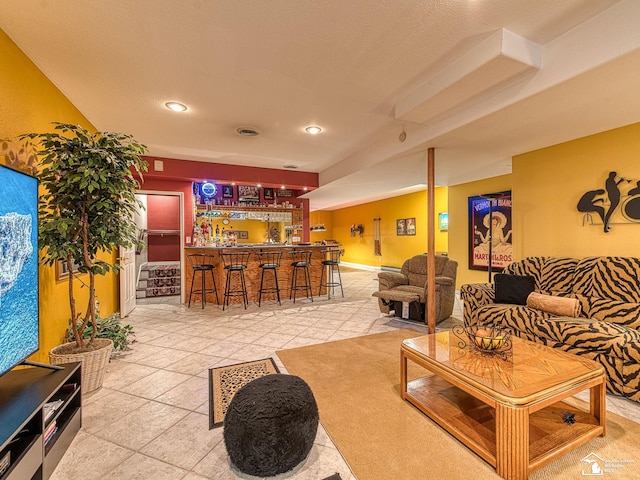 tiled living area with indoor wet bar, visible vents, and recessed lighting