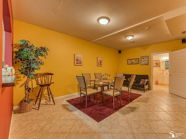 dining area with visible vents and a textured ceiling