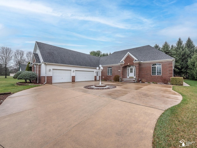 view of front of property with driveway, a shingled roof, a front yard, a garage, and brick siding