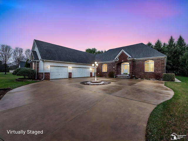 single story home featuring roof with shingles, concrete driveway, an attached garage, brick siding, and a front yard