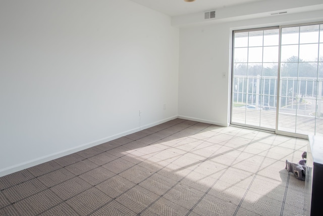 3559 Port Cove Dr Unit 25, Waterford, MI 48328 - unfurnished room with visible vents, baseboards, and light carpet