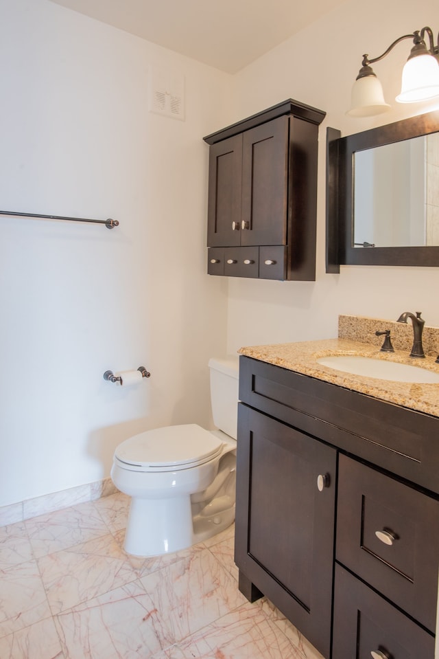 3559 Port Cove Dr Unit 25, Waterford, MI 48328 - bathroom with marble finish floor, toilet, vanity, and baseboards