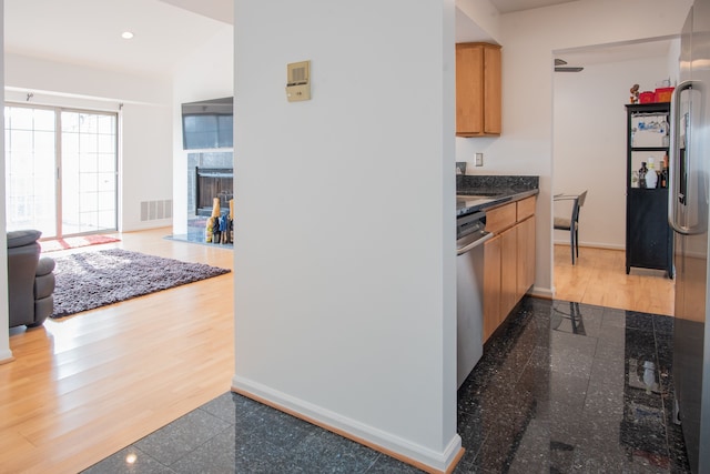3559 Port Cove Dr Unit 25, Waterford, MI 48328 - kitchen with a fireplace with flush hearth, granite finish floor, baseboards, visible vents, and appliances with stainless steel finishes