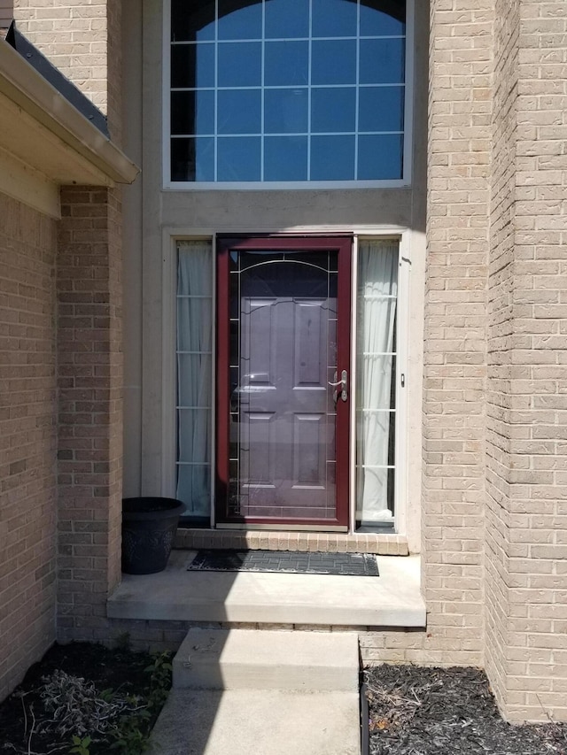 property entrance with brick siding