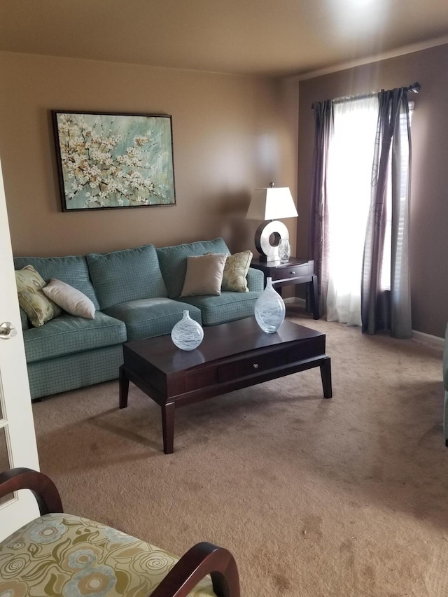 living area featuring light carpet