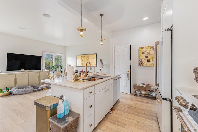 4311 Miracles Blvd Unit 22, Detroit, MI 48201 - kitchen with light wood-style flooring, a sink, stove, white cabinetry, and decorative light fixtures