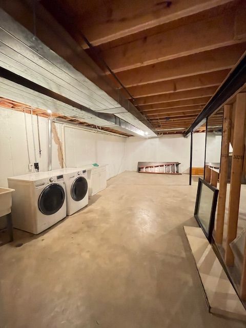 unfinished basement featuring washer and clothes dryer