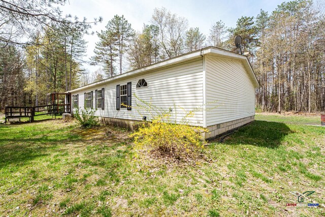 view of property exterior featuring a lawn