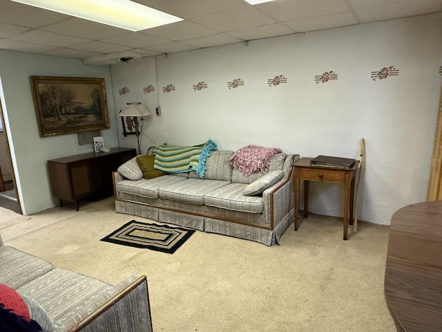 living room featuring light colored carpet and a drop ceiling