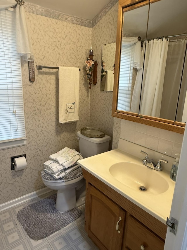 full bath with toilet, vanity, tile patterned floors, and curtained shower