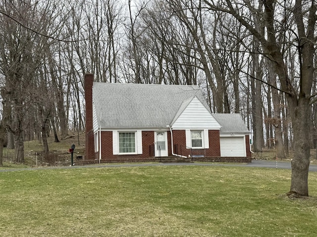view of front of property with driveway, brick siding, an attached garage, a shingled roof, and a front yard