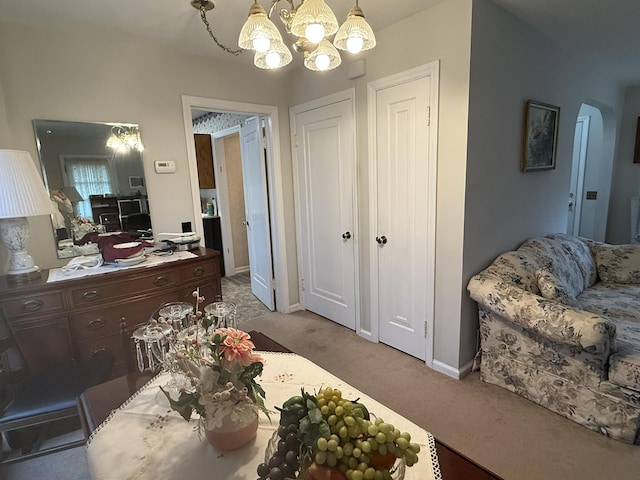interior space with a chandelier and baseboards