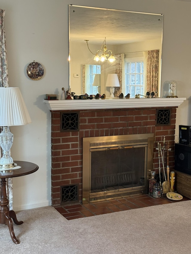 room details with a fireplace, carpet floors, baseboards, and an inviting chandelier