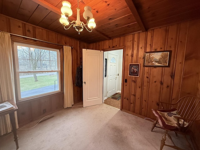 interior space with wood ceiling, an inviting chandelier, wooden walls, and light carpet