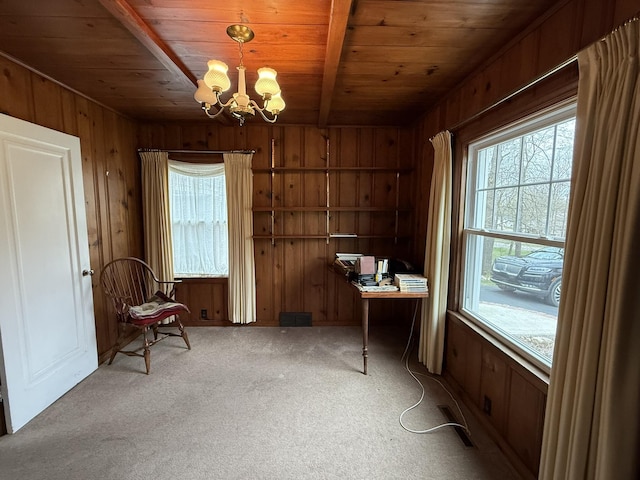 unfurnished office featuring wooden walls, wooden ceiling, carpet floors, and a notable chandelier