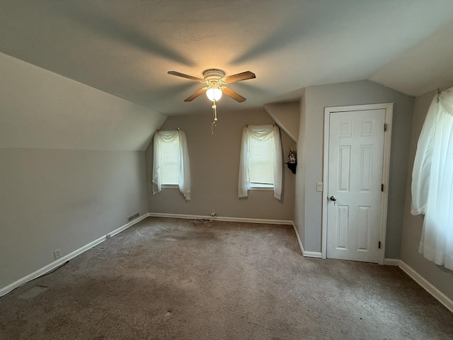 bonus room featuring lofted ceiling, a ceiling fan, and carpet