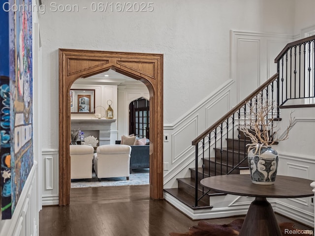 2010 W Valley Rd, Bloomfield Hills, MI 48304 - foyer entrance with a decorative wall, arched walkways, stairs, dark wood-type flooring, and a wainscoted wall