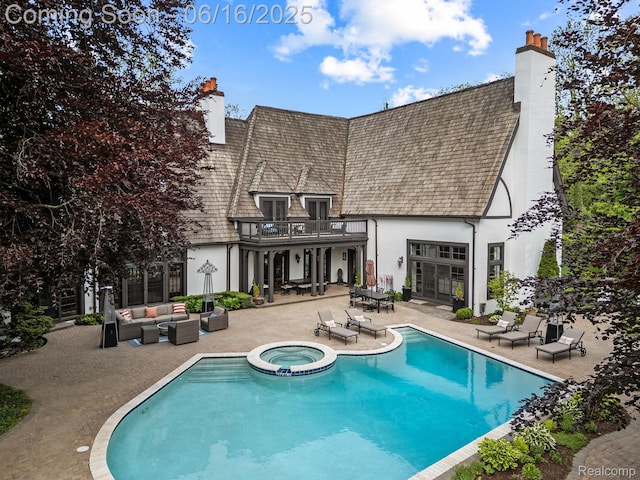 2010 W Valley Rd, Bloomfield Hills, MI 48304 - back of property featuring a chimney, a patio area, a balcony, an outdoor living space, and a pool with connected hot tub