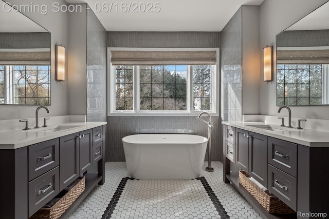 2010 W Valley Rd, Bloomfield Hills, MI 48304 - full bath featuring two vanities, a freestanding bath, tile walls, and tile patterned floors