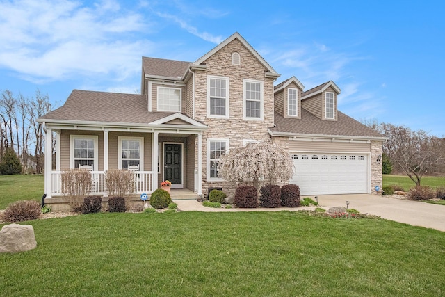 view of front of house featuring driveway, covered porch, stone siding, roof with shingles, and a front yard