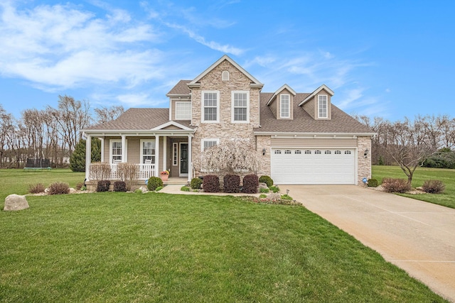 view of front of property featuring a front lawn, driveway, a porch, and stone siding