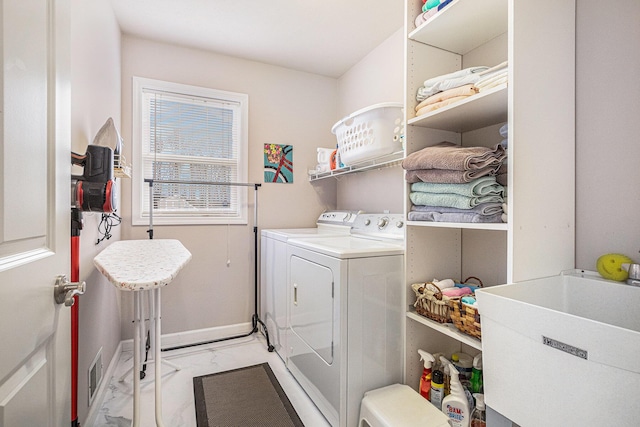 laundry room with a sink, marble finish floor, washer and dryer, laundry area, and visible vents