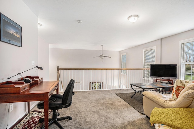 carpeted office featuring ceiling fan