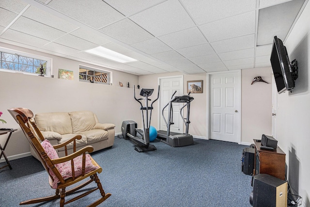 workout area with carpet, a drop ceiling, and baseboards