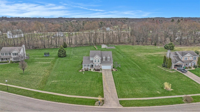 birds eye view of property with a view of trees