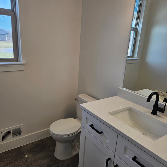 50638 Mistwood Dr, Macomb, MI 48042 - bathroom featuring healthy amount of natural light, vanity, toilet, and baseboards